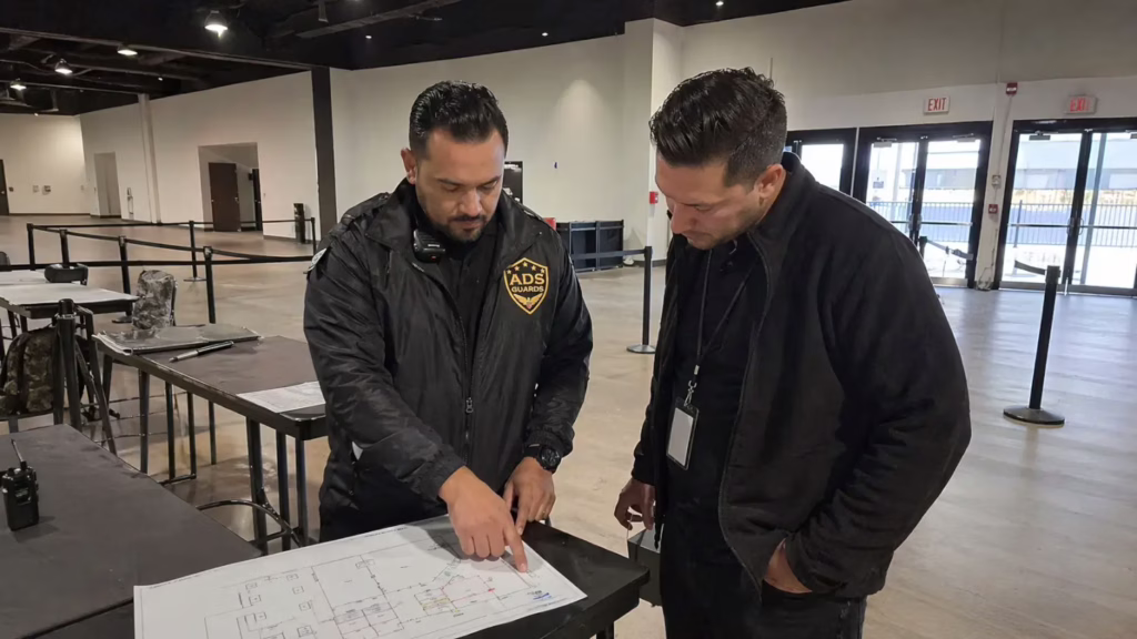ADS Guards security guard reviewing an event security risk assessment inside a venue before guests arrive