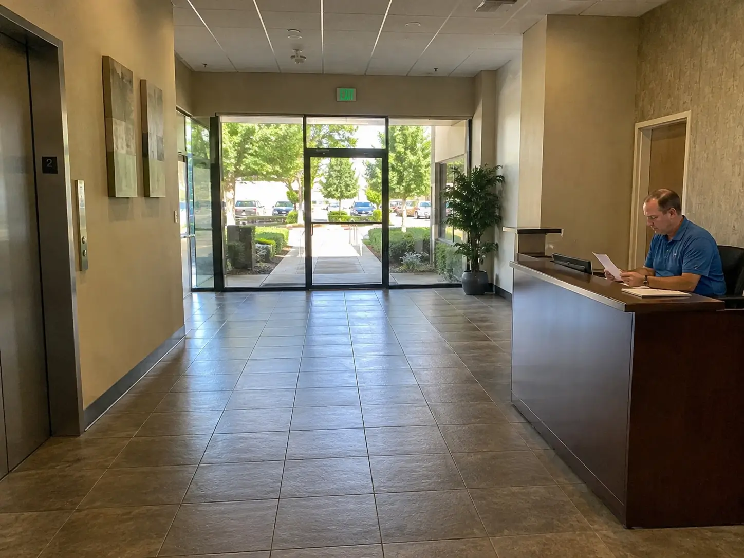 Commercial building lobby with a visible entrance, reception desk, and unobstructed visitor path for natural surveillance and access control.