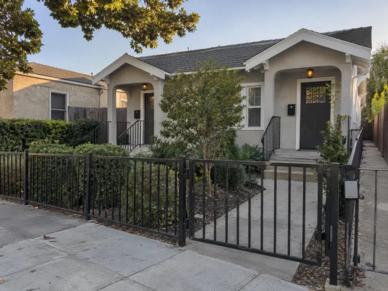 Two secured residential units behind a front gate, illustrating how to prevent squatters at a vacant property.